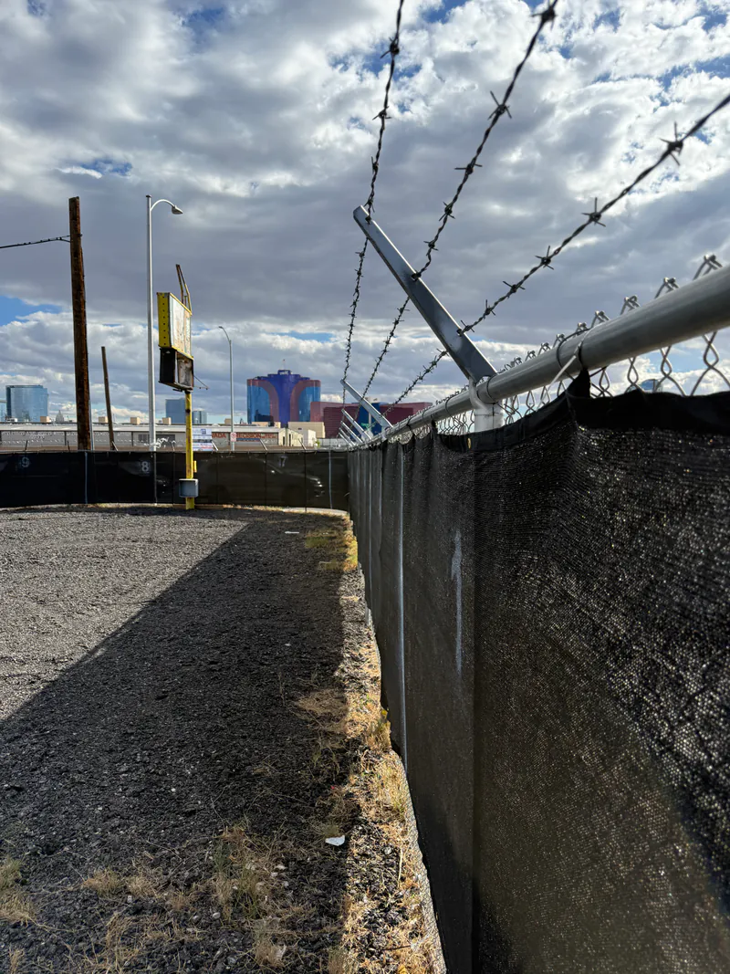 Barbed-wire security fencing at the Personal Storage Lot, secured outdoor RV and trailer storage near the Las Vegas Strip
