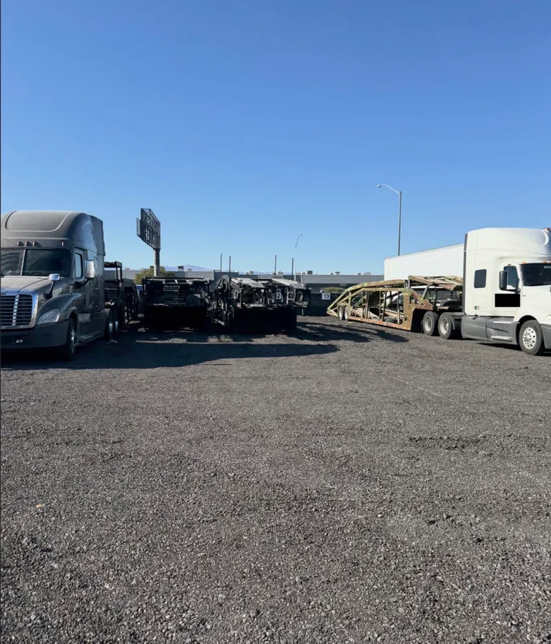 Tractor-trailers and car hauler trailers parked at the Strip Yard semi truck parking lot in Las Vegas